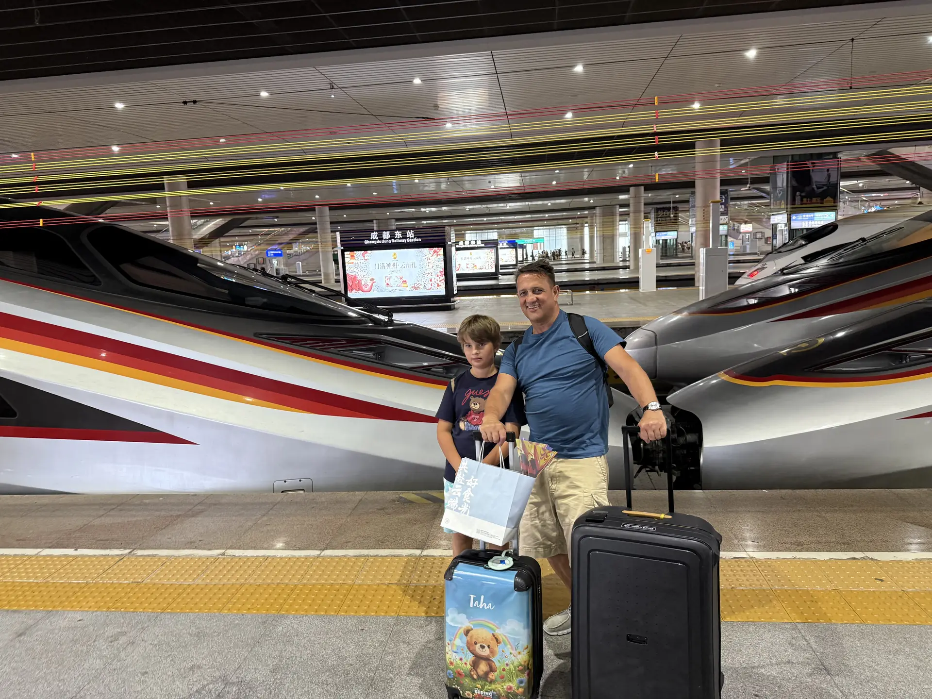 A father and child arriving by high-speed train in Chengdu